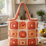 Coral sunset granny square tote with flower motifs and button closure