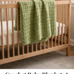 Green crochet baby blanket draped over a wooden crib