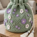 Sage green lattice crochet drawstring bag with wildflower appliques