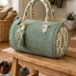 Sage green botanical barrel bag with fabric-wrapped handles