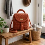 Terracotta basketweave crochet backpack with brass hardware