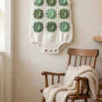 Mint succulent baby romper on a hanger
