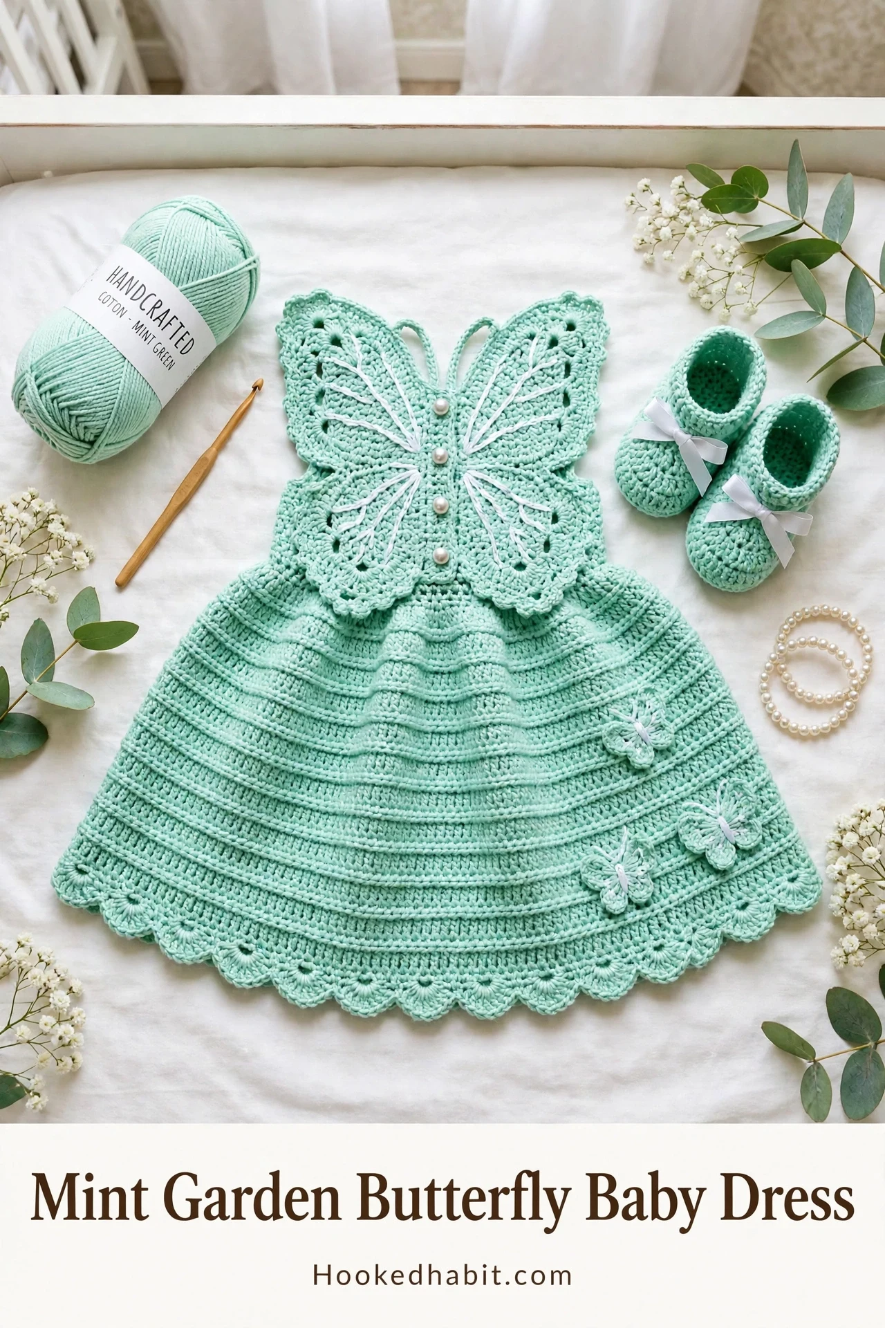 Mint Garden Butterfly Baby Dress flat lay in a nursery