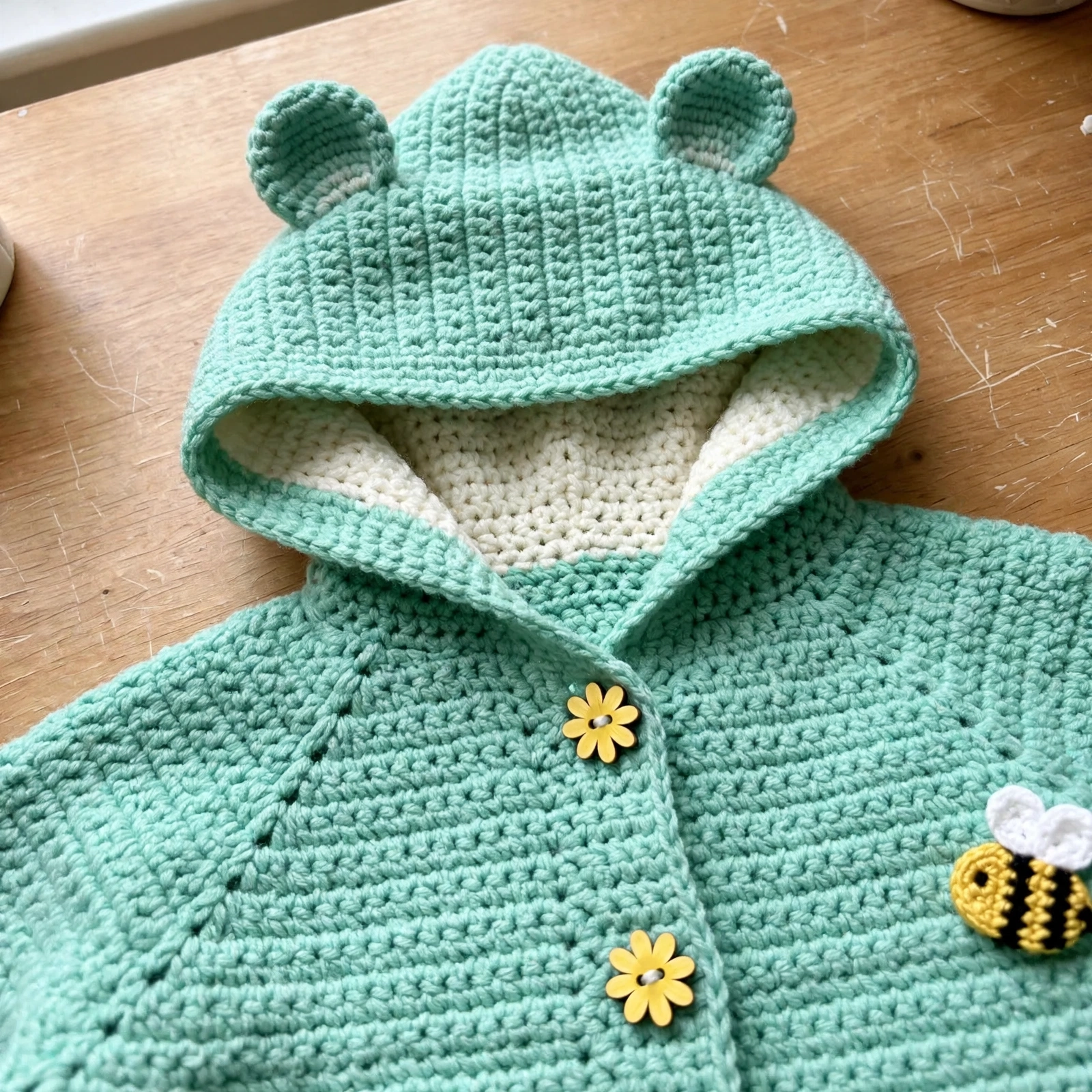 Cream-lined hood with bear ears detail