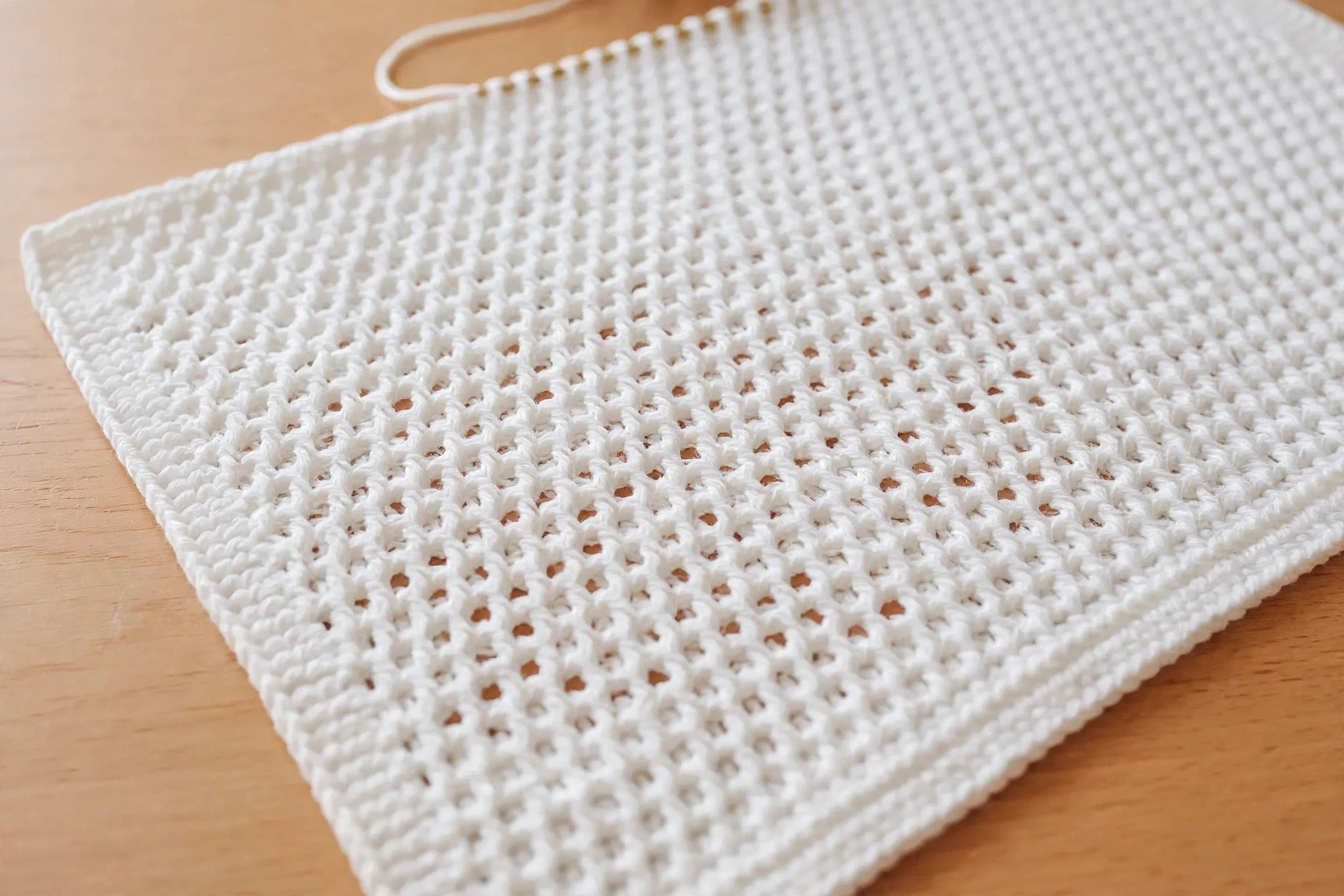 Close-up of Tunisian simple stitch texture on the white blanket