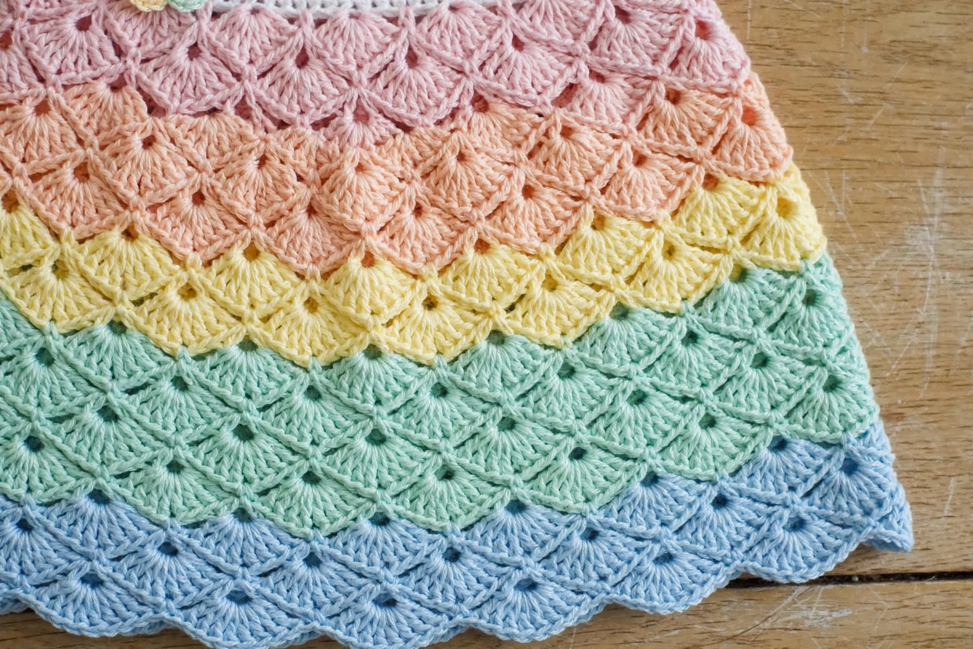 Close-up of pastel rainbow fan stitch pattern on the dress