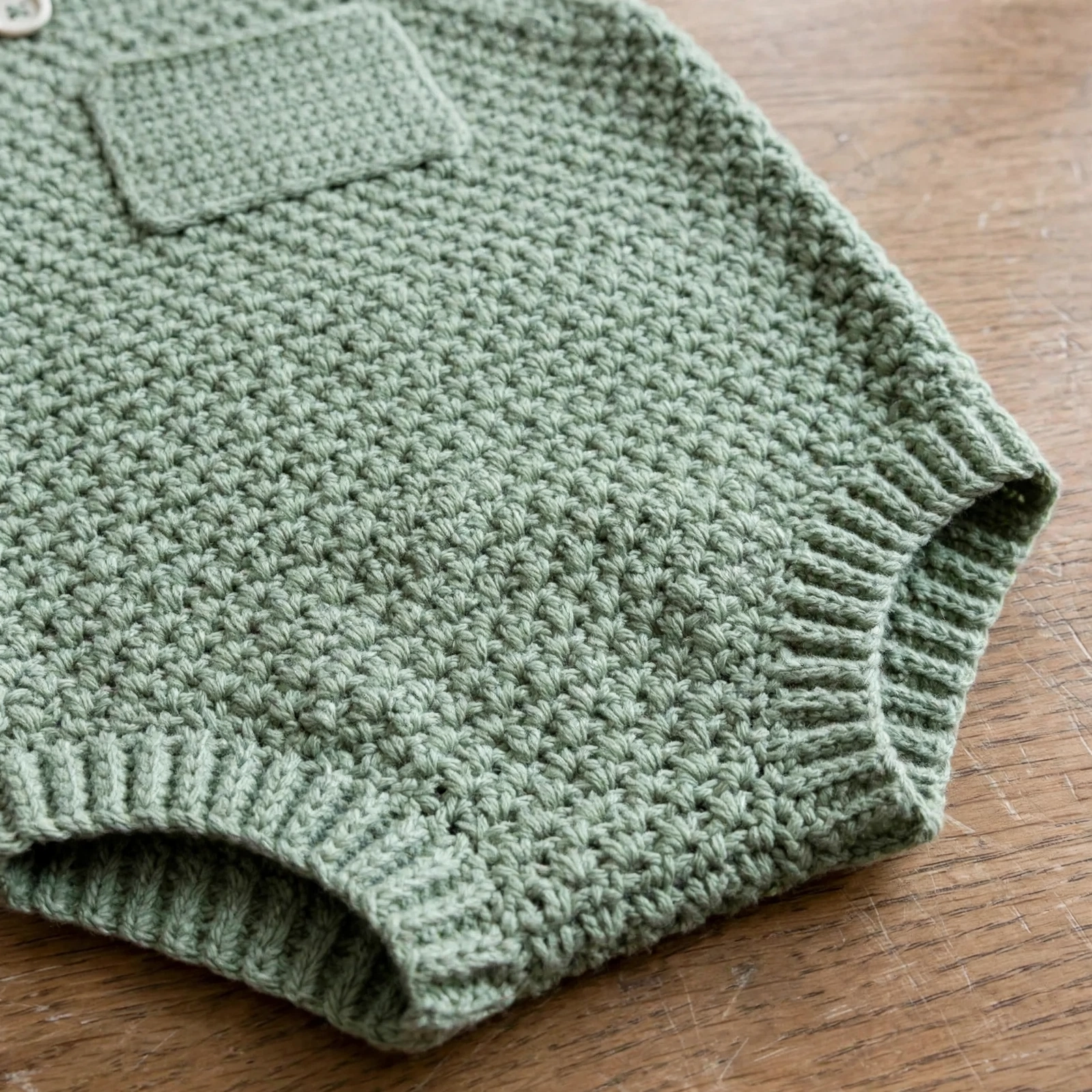 Close-up of moss stitch texture on the romper