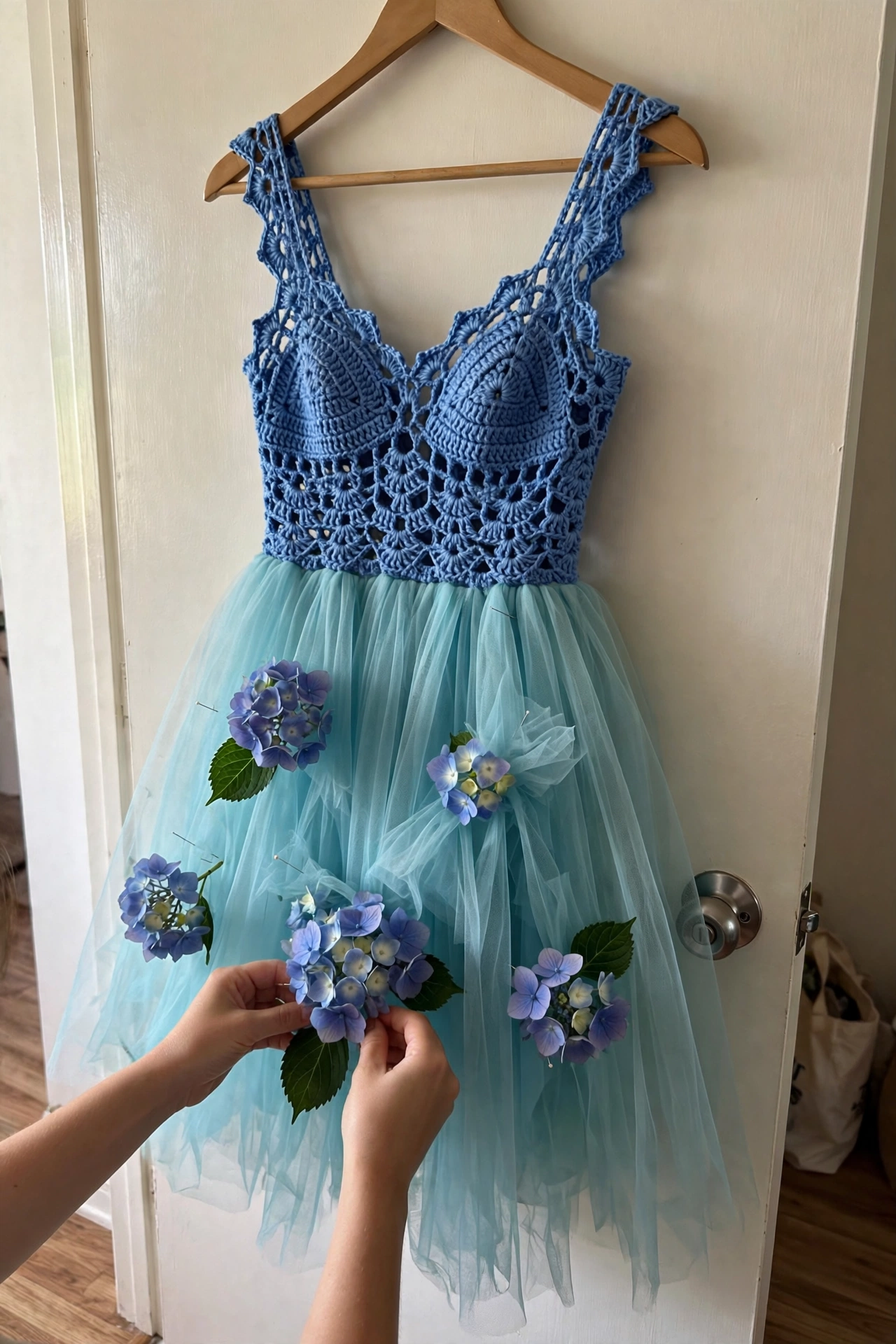 Hydrangea flowers being pinned on the tulle skirt